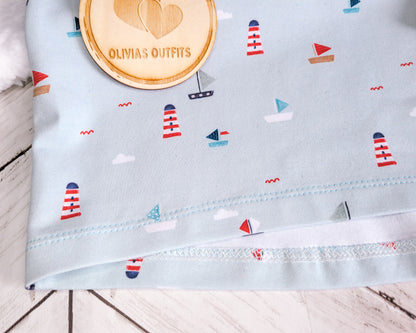 Close-up detail of the hem stitching on a handmade Oversize Tee in nautical fabric with boats and lighthouses